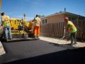 Laying and smooth asphalt on a new driveway in Winnipeg