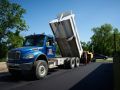 The Superior Asphalt truck unloading hot asphalt onto a new driveway in Winnipeg