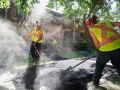 Superior Asphalt raking fresh, hot asphalt on a new walkway in Winnipeg