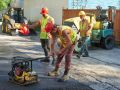 The Superior Asphalt team smoothing out a new driveway in Winnipeg