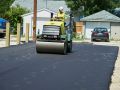 Flattening fresh asphalt on a new road in Winnipeg